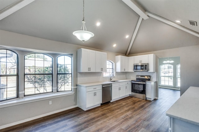 kitchen featuring white cabinetry, appliances with stainless steel finishes, sink, and hanging light fixtures