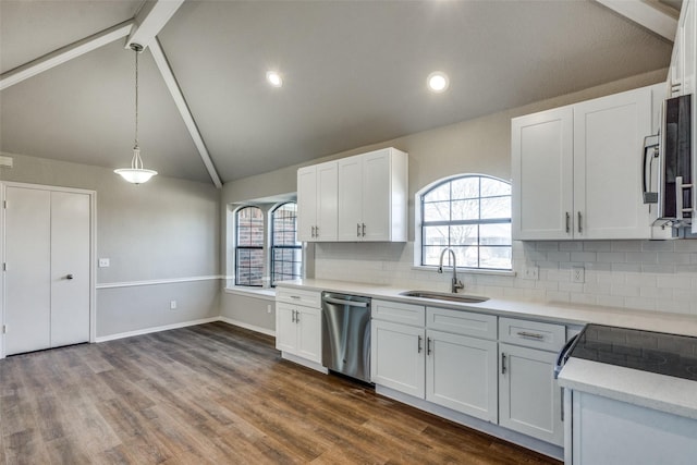 kitchen with white cabinetry, appliances with stainless steel finishes, sink, and decorative light fixtures