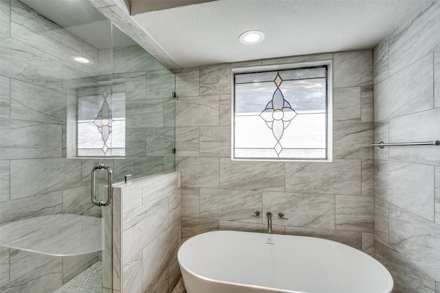 bathroom with independent shower and bath and a textured ceiling