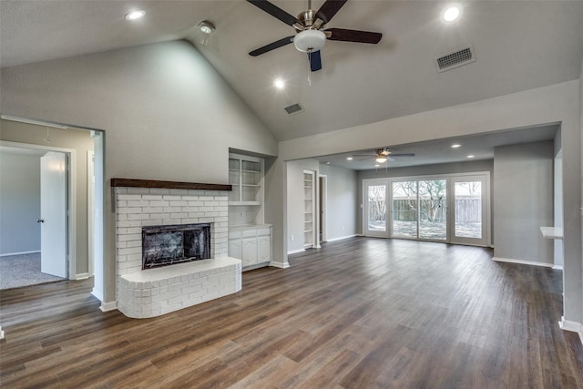 unfurnished living room with ceiling fan, high vaulted ceiling, a fireplace, dark hardwood / wood-style flooring, and built in shelves