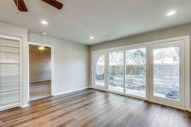 interior space featuring hardwood / wood-style flooring, built in features, and ceiling fan