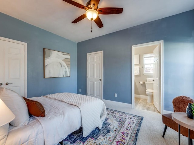 carpeted bedroom featuring connected bathroom and ceiling fan