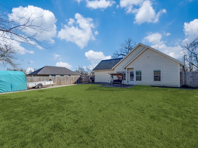 rear view of house featuring a patio and a yard