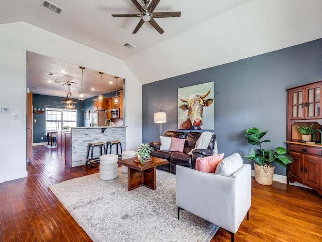 living room with vaulted ceiling, ceiling fan, and dark hardwood / wood-style flooring