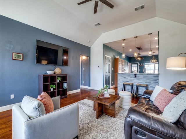 living room with hardwood / wood-style floors, vaulted ceiling, sink, and ceiling fan