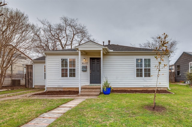 bungalow-style home with a front yard