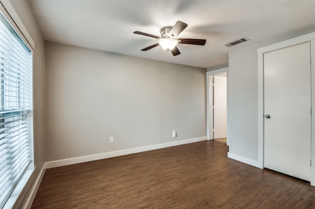 unfurnished bedroom featuring ceiling fan and dark hardwood / wood-style floors