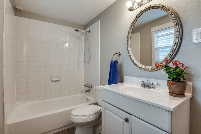 full bathroom with tiled shower / bath combo, vanity, and toilet