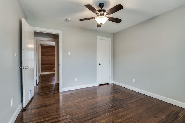 unfurnished bedroom featuring dark wood-type flooring and ceiling fan