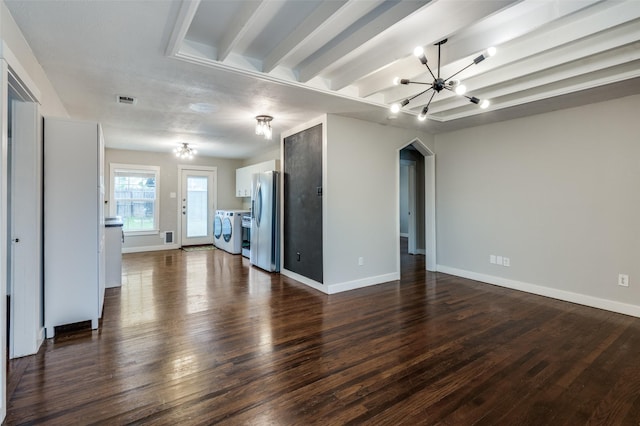 unfurnished living room with beam ceiling, washing machine and dryer, dark wood-type flooring, and an inviting chandelier