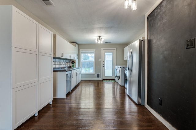 kitchen with sink, white cabinetry, dark hardwood / wood-style floors, independent washer and dryer, and stainless steel appliances