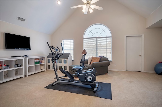 exercise area featuring high vaulted ceiling, light colored carpet, and ceiling fan