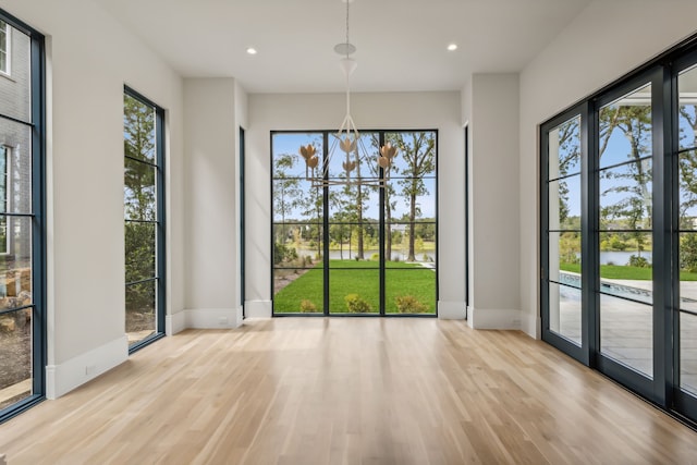 unfurnished dining area with light hardwood / wood-style floors