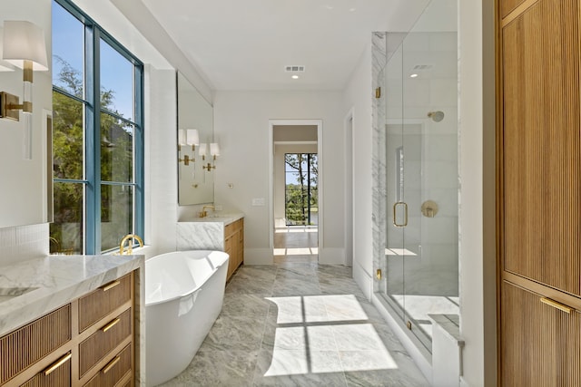 bathroom featuring vanity and plus walk in shower