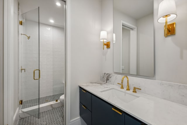 bathroom with vanity, toilet, tile patterned floors, and a shower with shower door