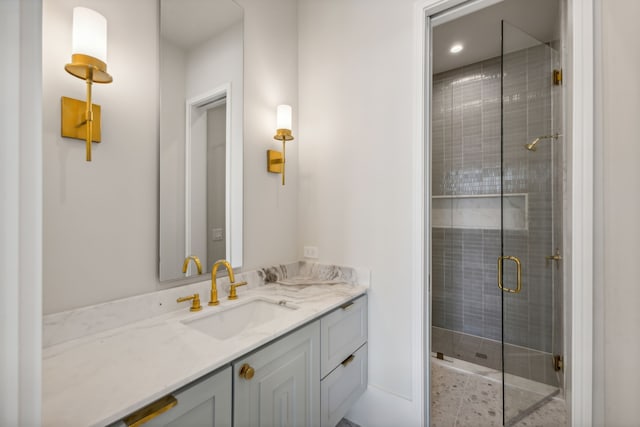 bathroom featuring walk in shower and vanity