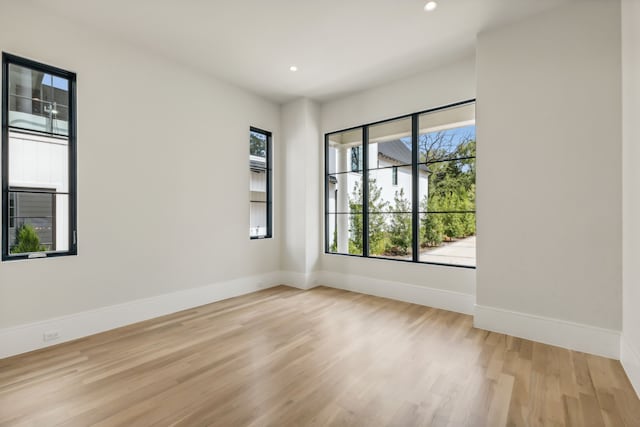 spare room with light hardwood / wood-style flooring