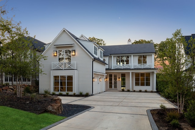 view of front of house featuring a balcony and a garage