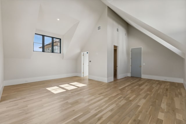 bonus room with high vaulted ceiling and light hardwood / wood-style flooring