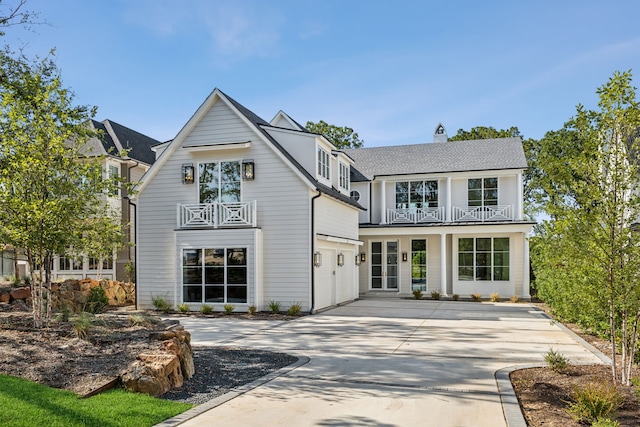 view of front of home with a garage and a balcony