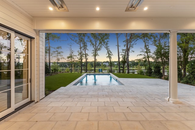 view of pool at dusk