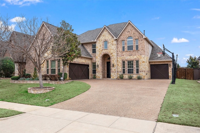 view of front of property with a garage and a front lawn