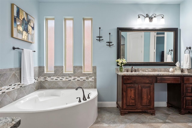 bathroom featuring a washtub and vanity