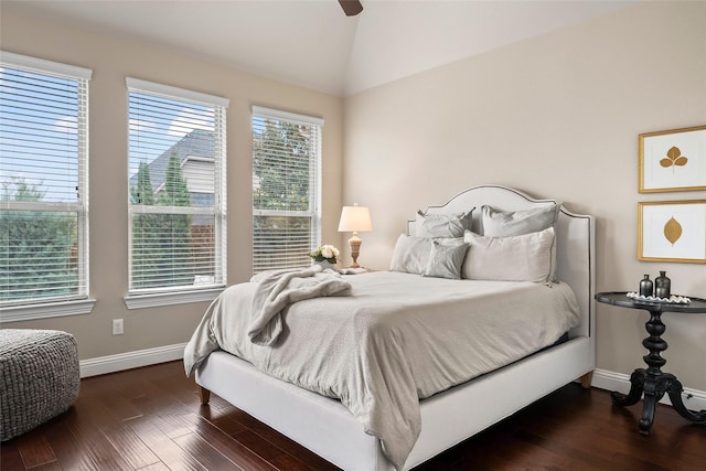 bedroom with ceiling fan, lofted ceiling, and dark hardwood / wood-style flooring