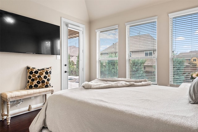 bedroom featuring lofted ceiling, access to outside, and dark hardwood / wood-style floors