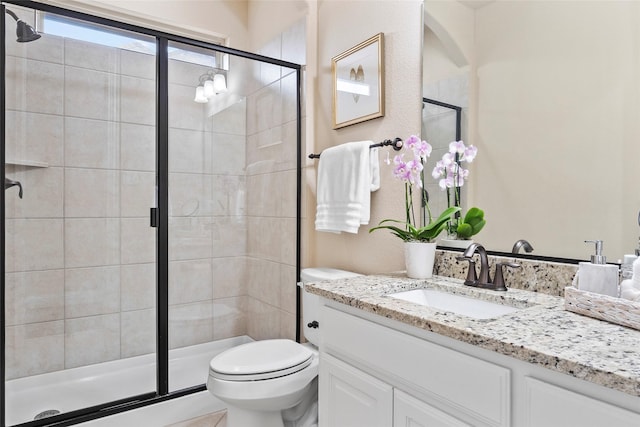 bathroom with vanity, toilet, and an enclosed shower