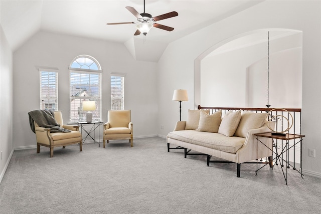 sitting room with light carpet, vaulted ceiling, and ceiling fan