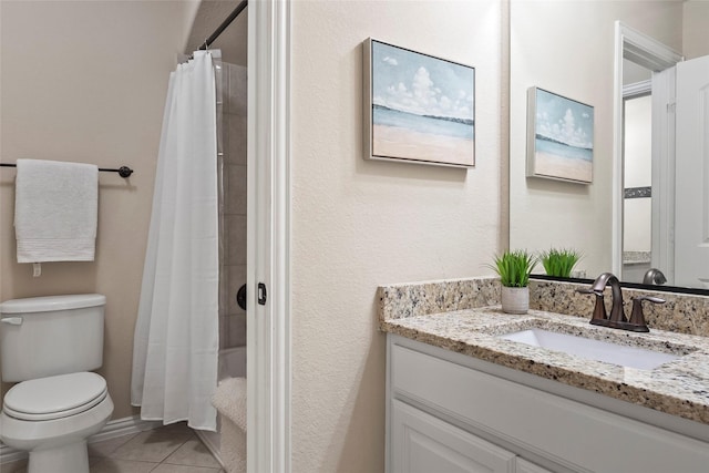 bathroom featuring tile patterned flooring, vanity, walk in shower, and toilet