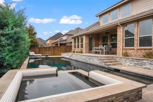 view of pool with a patio and ceiling fan