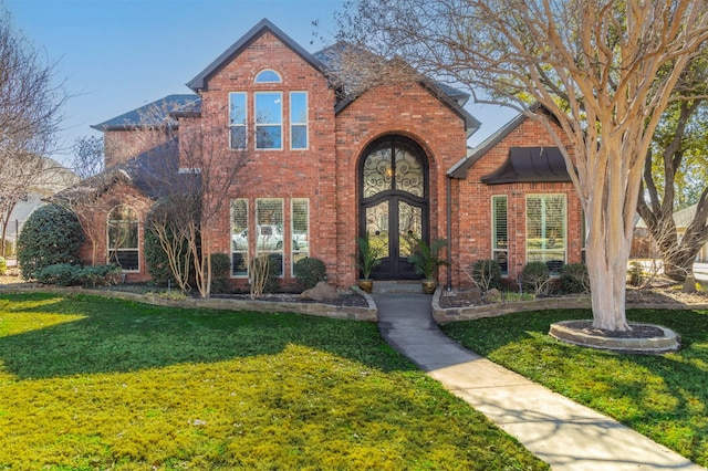 view of front of home with french doors and a front lawn