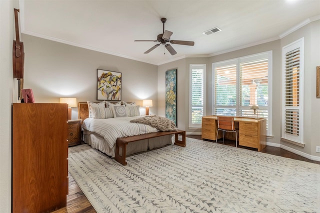 bedroom with wood-type flooring, ornamental molding, and ceiling fan