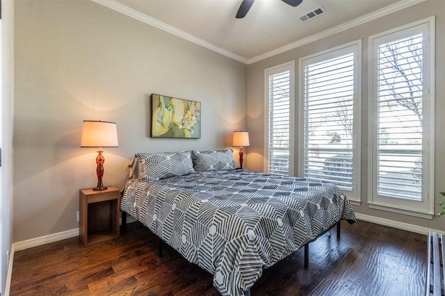 bedroom with crown molding, dark hardwood / wood-style floors, and ceiling fan