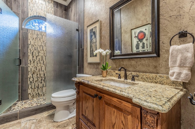 bathroom featuring walk in shower, vanity, and toilet