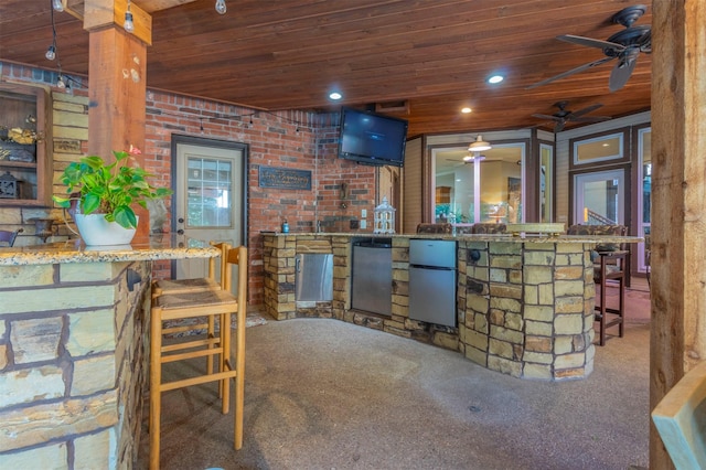 bar featuring ceiling fan, carpet, wooden ceiling, and refrigerator