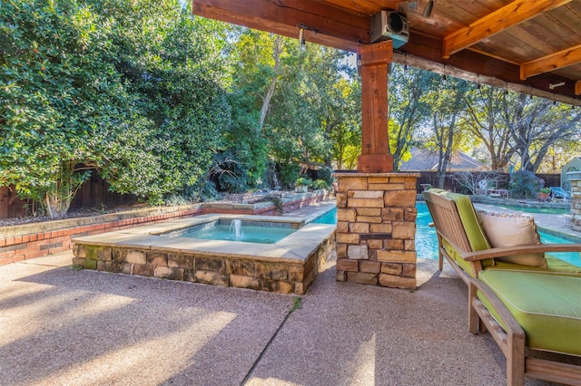 view of patio / terrace featuring an in ground hot tub