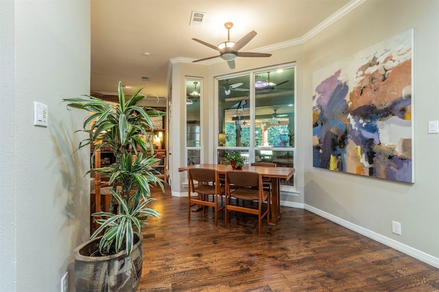 dining room featuring crown molding, dark wood-type flooring, and ceiling fan