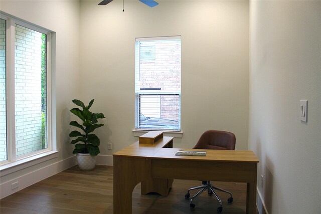 home office with wood finished floors, ceiling fan, and baseboards