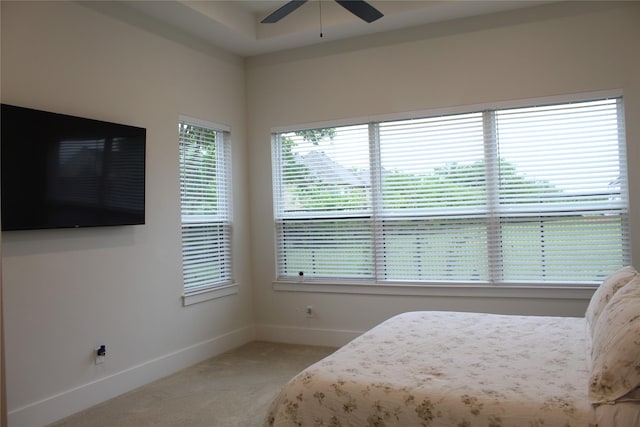 bedroom featuring ceiling fan, light colored carpet, and baseboards