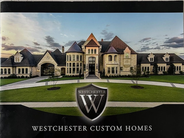 french provincial home featuring a standing seam roof, stone siding, a front lawn, and a chimney