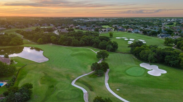 drone / aerial view featuring a water view, a residential view, and view of golf course