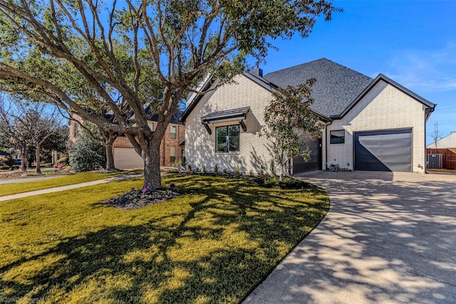 ranch-style house featuring a front lawn, concrete driveway, an attached garage, and brick siding