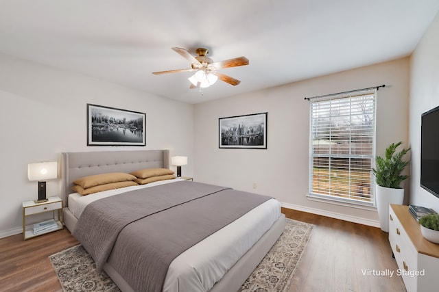 bedroom featuring dark hardwood / wood-style floors and ceiling fan