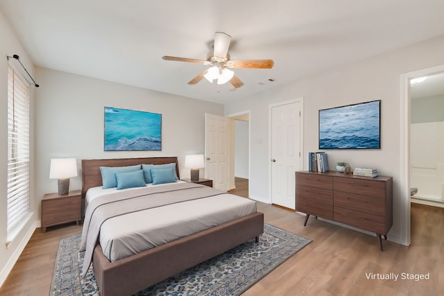 bedroom featuring multiple windows, hardwood / wood-style floors, and ceiling fan