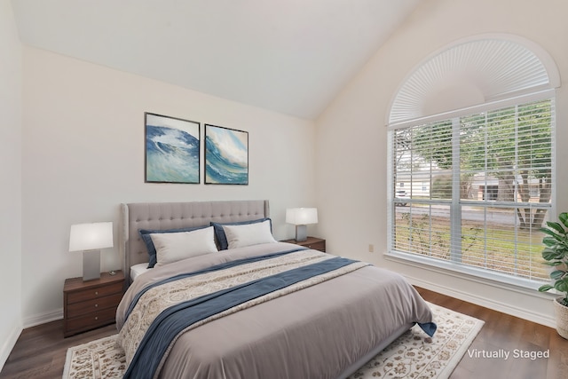 bedroom with dark wood-type flooring and vaulted ceiling