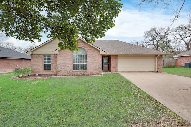 ranch-style house featuring a garage, a front yard, and cooling unit