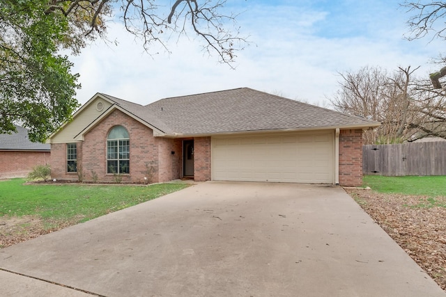 ranch-style home featuring a garage and a front lawn